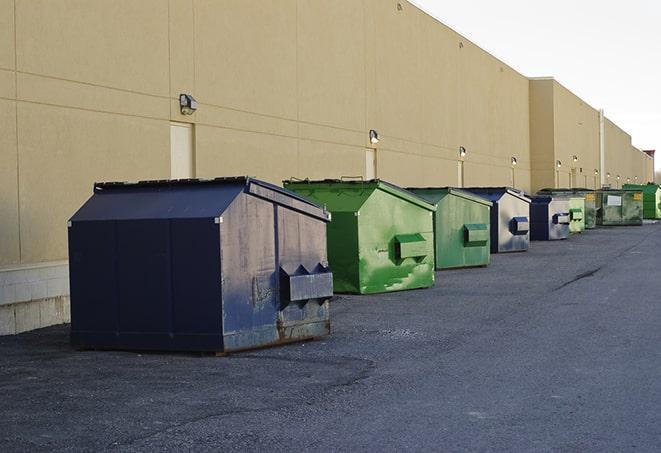 construction site debris being cleared away by dumpsters in Baldwinville, MA